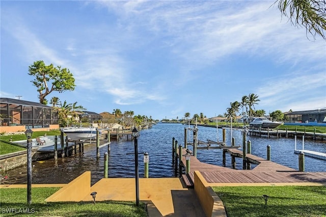 dock area featuring a lawn and a water view