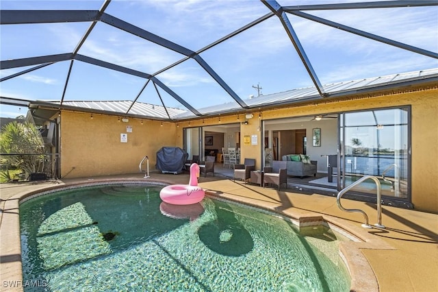 view of pool with outdoor lounge area, a lanai, and a patio