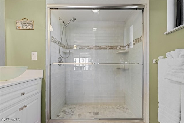 bathroom featuring vanity and an enclosed shower