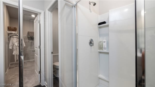 bathroom featuring toilet and walk in shower