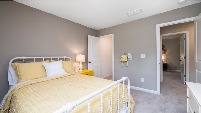 bedroom featuring light colored carpet