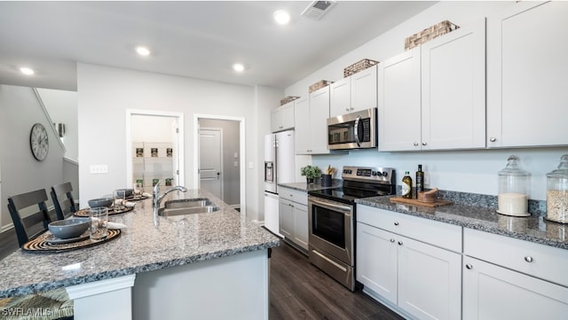 kitchen featuring white cabinets, sink, light stone countertops, dark hardwood / wood-style flooring, and stainless steel appliances