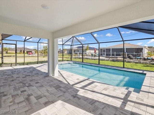 view of pool featuring glass enclosure and a patio