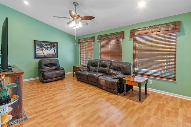 living room with light wood-type flooring, vaulted ceiling, and ceiling fan