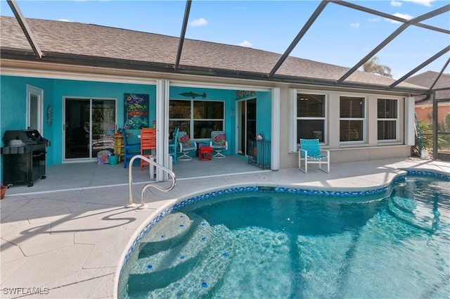 view of swimming pool featuring a grill, a patio area, and glass enclosure