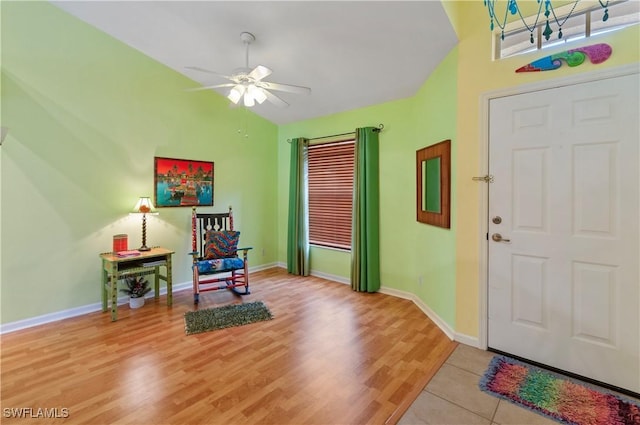 entrance foyer with ceiling fan, light hardwood / wood-style floors, and vaulted ceiling