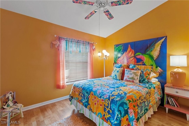 bedroom featuring ceiling fan, wood-type flooring, and vaulted ceiling