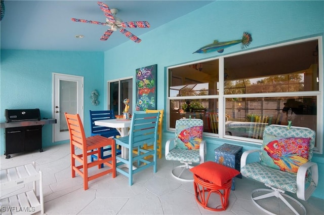 interior space featuring ceiling fan and lofted ceiling