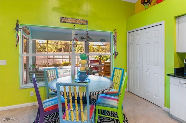 dining space featuring light tile patterned floors and a healthy amount of sunlight