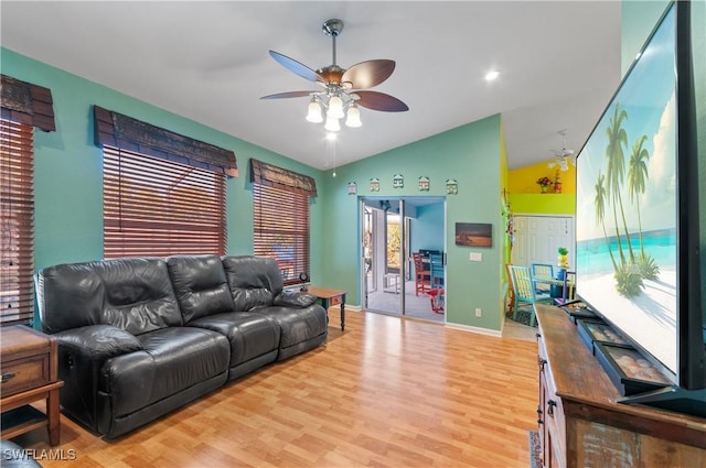 living room with hardwood / wood-style flooring, ceiling fan, and lofted ceiling