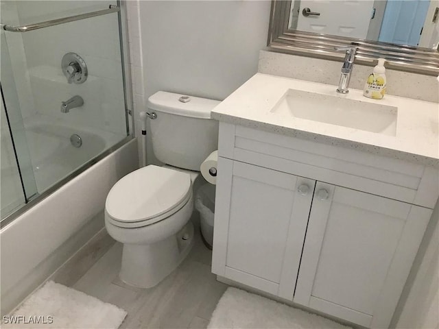 bathroom featuring toilet, washtub / shower combination, and vanity