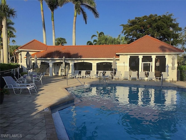 pool featuring a patio area and fence