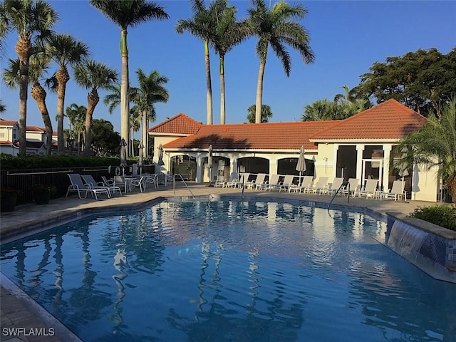 pool featuring a patio area and fence