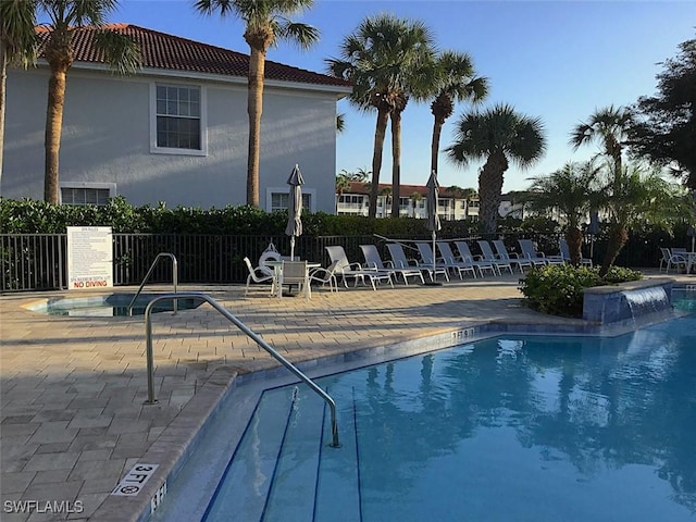 pool with fence and a patio