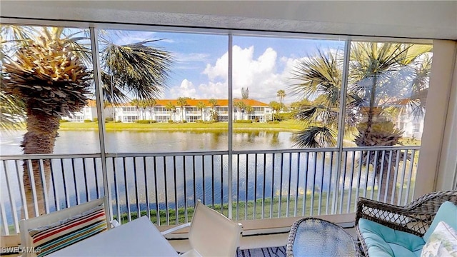 sunroom / solarium featuring a water view