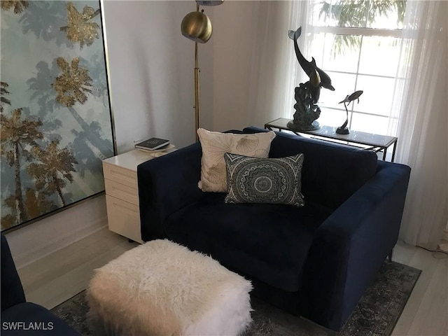 living area featuring light wood-style floors and wallpapered walls