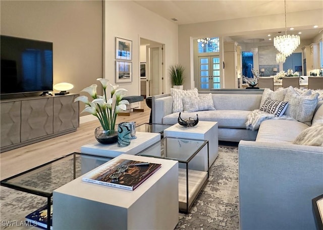 living room featuring wood-type flooring and a notable chandelier