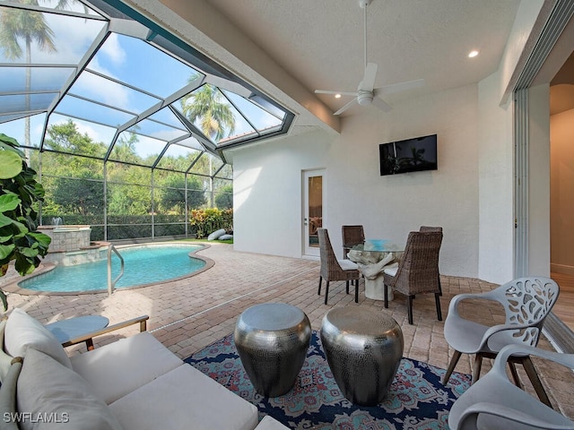 view of pool featuring a patio area, ceiling fan, and glass enclosure