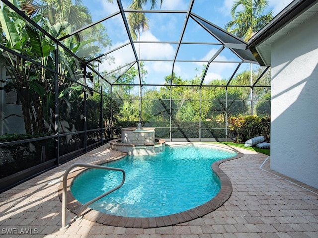 view of pool with an in ground hot tub, a lanai, and a patio