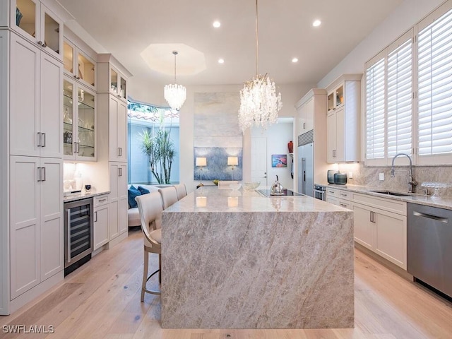 kitchen featuring wine cooler, decorative light fixtures, and a kitchen island