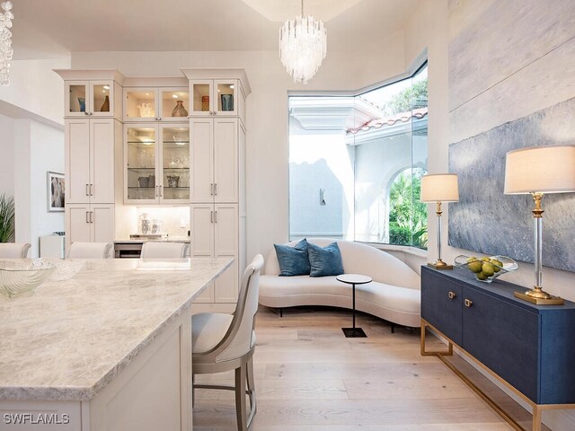 living area featuring a chandelier and light wood-type flooring