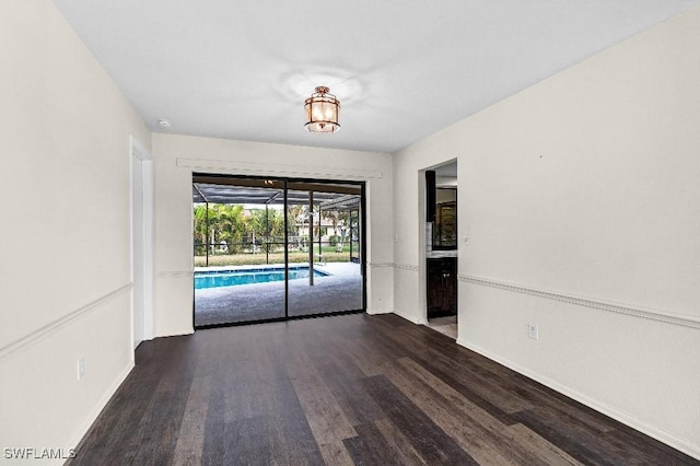 spare room featuring dark wood-type flooring