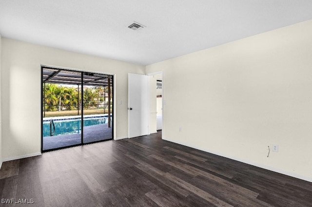 unfurnished room featuring dark hardwood / wood-style flooring