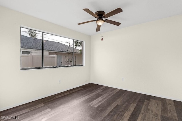 unfurnished room with ceiling fan and dark hardwood / wood-style flooring