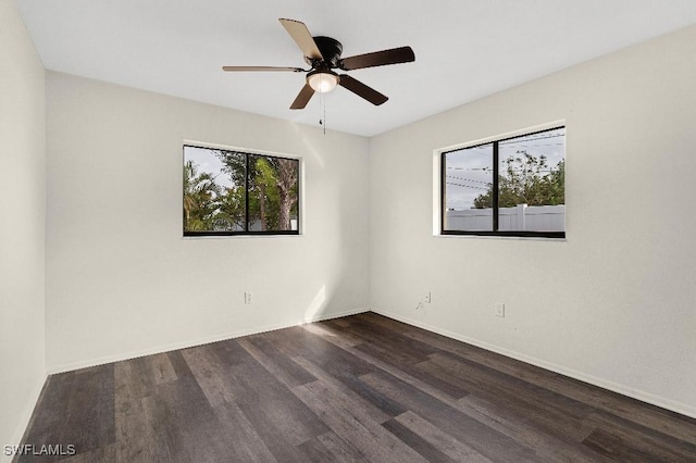 unfurnished room with ceiling fan and dark hardwood / wood-style flooring