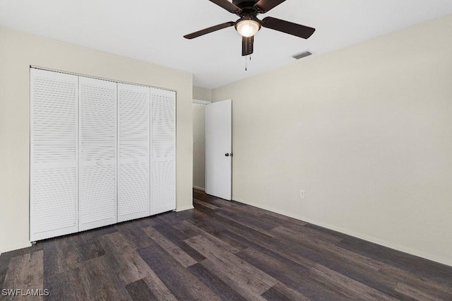 unfurnished bedroom featuring a closet, ceiling fan, and dark wood-type flooring