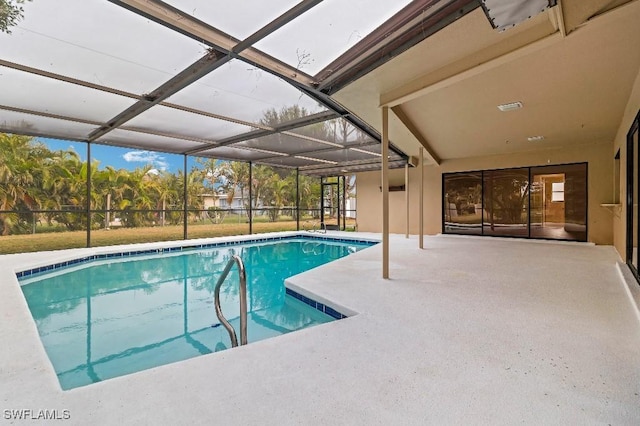 view of pool featuring glass enclosure and a patio area