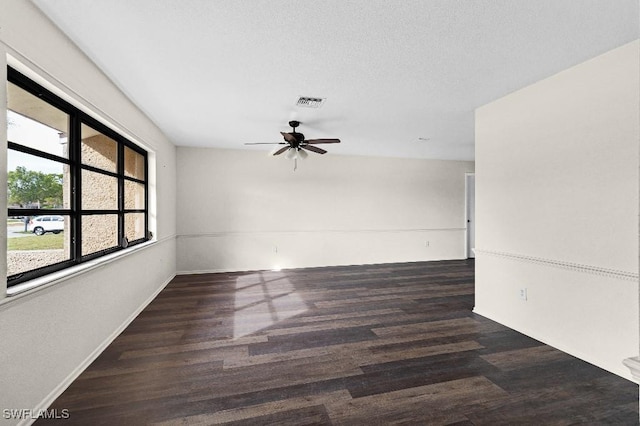 empty room with dark hardwood / wood-style floors and ceiling fan