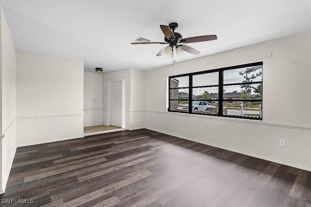 unfurnished room with dark hardwood / wood-style floors and ceiling fan