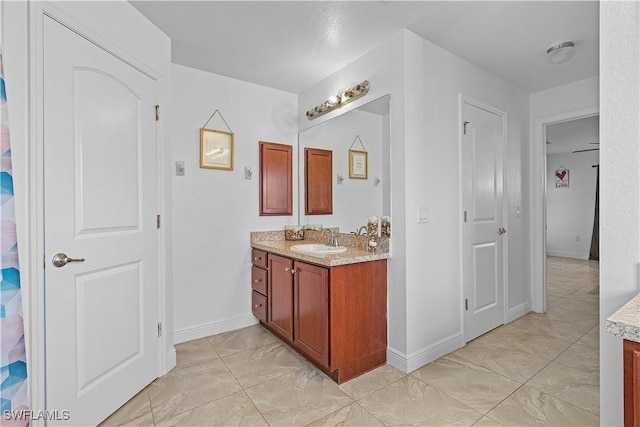 bathroom featuring ceiling fan and vanity