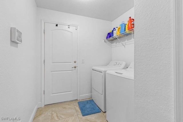 washroom featuring light tile patterned floors and washing machine and clothes dryer