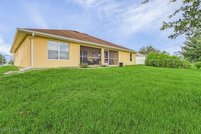 rear view of house with a lawn