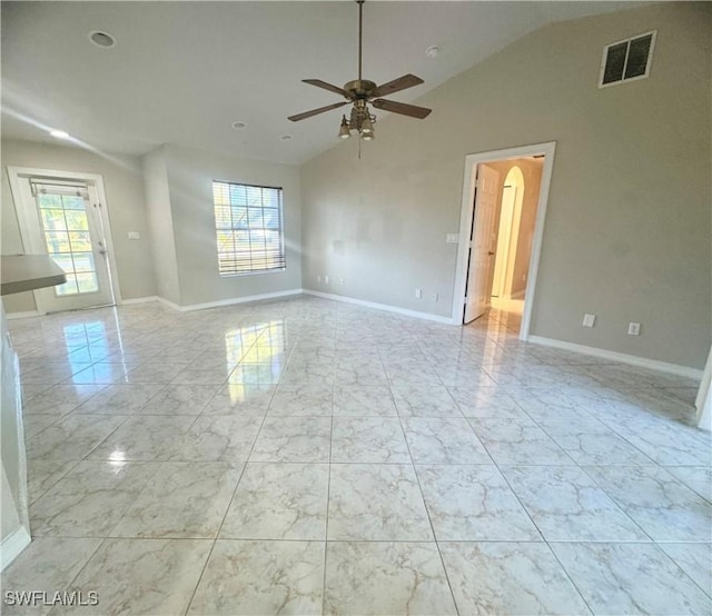 spare room with vaulted ceiling, ceiling fan, and a healthy amount of sunlight