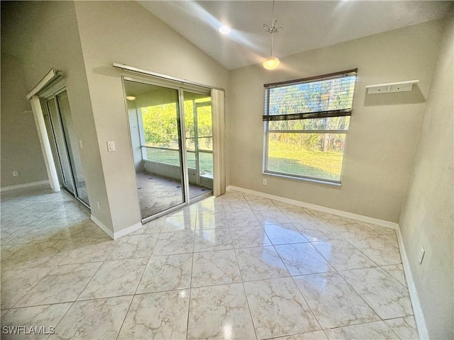 empty room with a wealth of natural light and vaulted ceiling