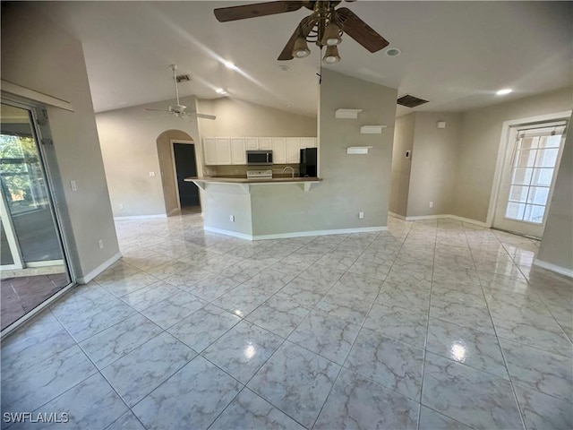 unfurnished living room with ceiling fan and lofted ceiling