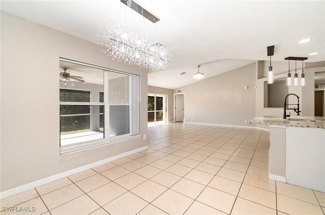 unfurnished living room with light tile patterned floors, ceiling fan with notable chandelier, lofted ceiling, and sink