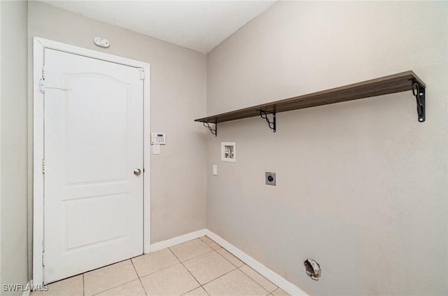 laundry area with electric dryer hookup, light tile patterned floors, and washer hookup