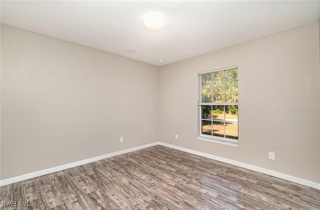 unfurnished room with hardwood / wood-style flooring