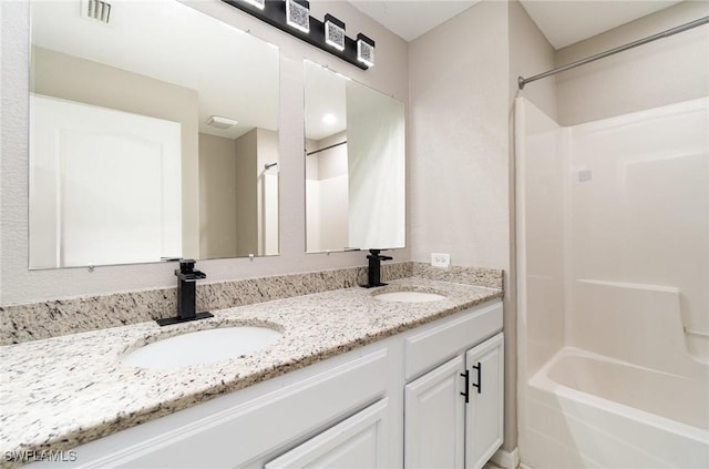 bathroom with vanity and shower / washtub combination