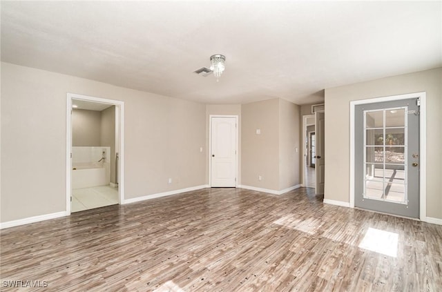 spare room featuring hardwood / wood-style flooring