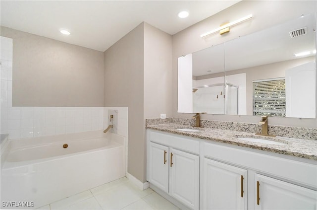 bathroom with vanity, tile patterned flooring, and plus walk in shower