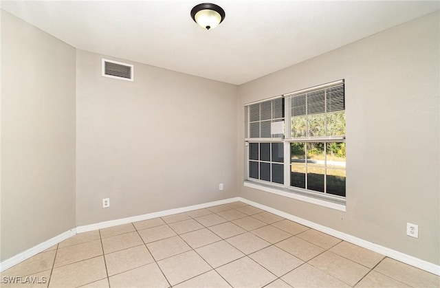 spare room featuring light tile patterned floors