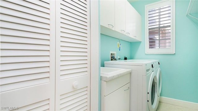 laundry room with washer and clothes dryer and cabinets