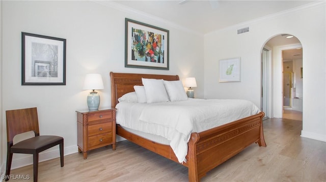 bedroom with crown molding, light hardwood / wood-style flooring, and ceiling fan