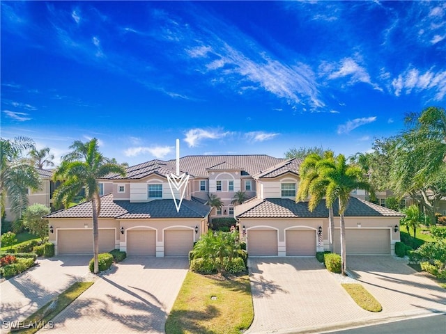 mediterranean / spanish-style home with a garage