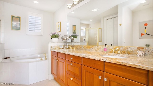 bathroom with tile patterned flooring, vanity, and plus walk in shower